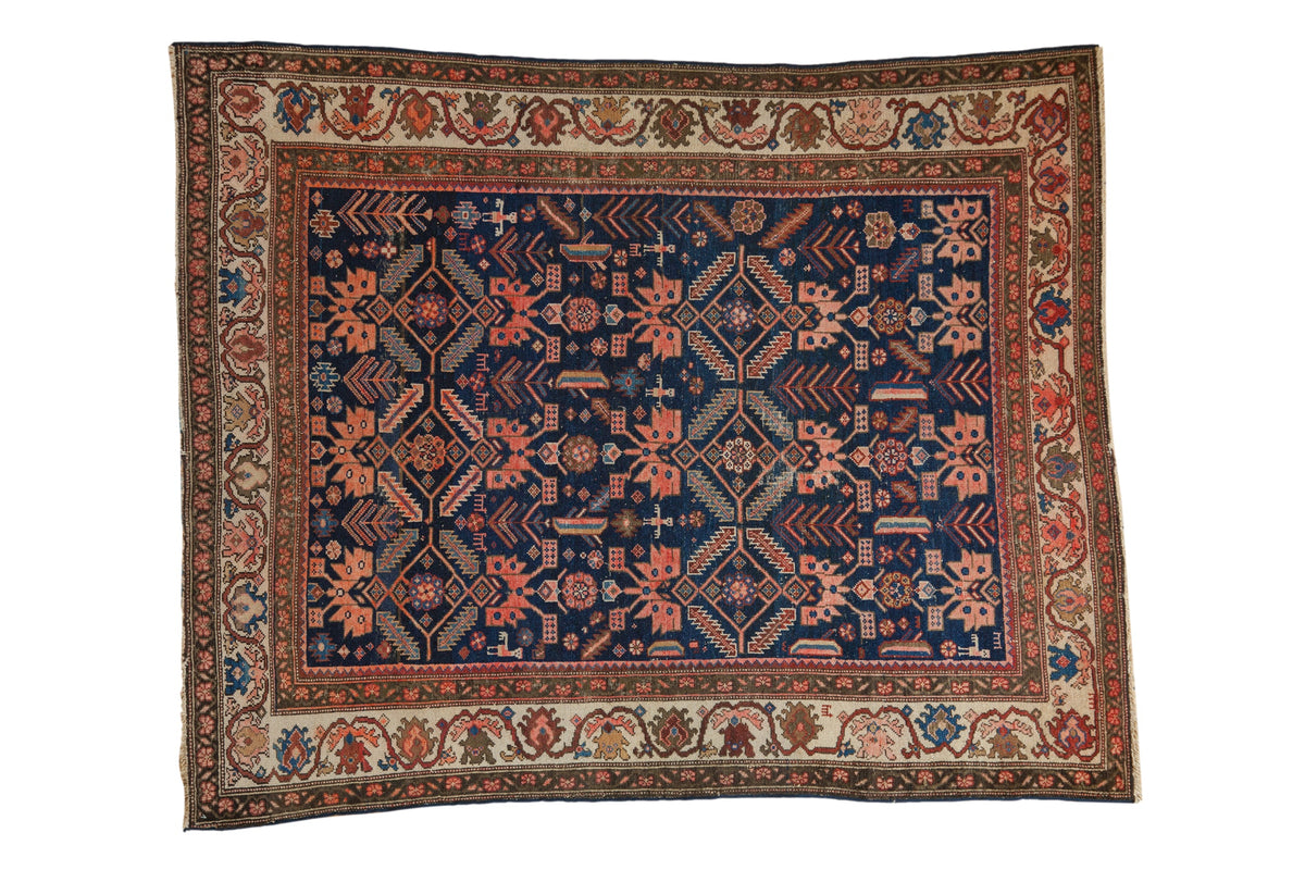 Antique Persian Malayer rug with a sapphire blue field covered in geometric plants, palmettes, and animals.