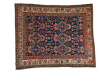 Antique Persian Malayer rug with a sapphire blue field covered in geometric plants, palmettes, and animals.