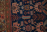 Detail of playful stylized animal and human figures on the sapphire blue field of an antique Malayer rug.