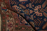 Rich sapphire blue field and intricate ivory border of an antique hand-knotted Persian Malayer rug.
