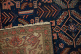View of an antique Malayer rug's hand-knotted back and sapphire blue wool pile.