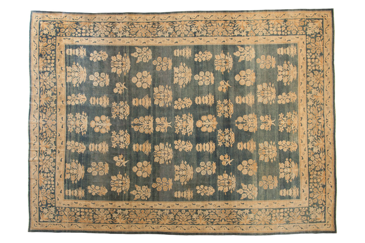 Distressed antique Kerman carpet, allover floral bouquets on abrashed blue, with millefleur border.