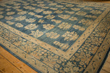 Distressed antique Kerman carpet corner, exhibiting blue floral bouquets and millefleur border.