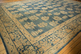 Antique distressed Persian Kerman carpet corner, ivory floral bouquets on denim blue, millefleur border.