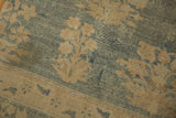 Faded floral bouquets on abrashed denim blue ground of distressed Kerman carpet.