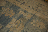 Textured pile close-up of antique Persian Kerman carpet, revealing abrashed blue and faded floral design.
