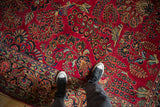 Showing the rich texture and scale of a vintage American Sarouk carpet with a cherry red floral field.