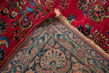 The dense hand-knotted foundation and cherry red pile of a vintage American Sarouk carpet.