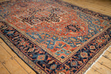 Angled view of an antique Heriz carpet's low pile and intricate Turtle Samovar border.