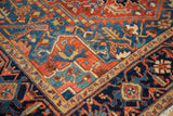 Close-up on the Turtle Samovar and vine border motif of an antique Persian Heriz carpet.