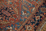 Detail of an antique Heriz carpet's Turtle Samovar border in brick red and sapphire blue.