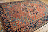 Angled view of an antique Heriz carpet's navy blue border with Turtle Samovar motifs.