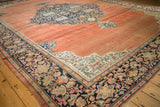 Quarter-map corner spandrel and wide floral border on an antique Farahan Sarouk carpet.