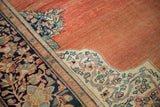 Intricate ivory corner spandrel and navy border on an antique Farahan Sarouk's abrashed terracotta field.