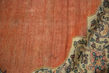 Low pile and visible knot heads on the abrashed terracotta field of an antique Farahan Sarouk.