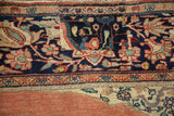 A historical patch repair shown within the densely ornamented navy blue border of a Persian carpet.