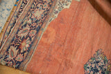 Floral border and ivory corner spandrel on an antique Farahan Sarouk's abrashed terracotta field.