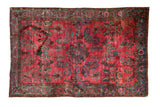 Antique Mohajeran Sarouk rug with weeping willow and floral motifs on an abrashed raspberry red field.