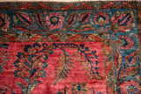 Antique Sarouk rug corner with raspberry red ferns and a sapphire blue floral border.
