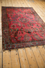 Angled view of an antique Mohajeran Sarouk rug showing its traditional weeping willow design.