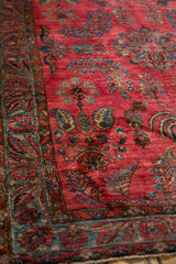Angled detail of a Mohajeran Sarouk's glossy wool pile, showing weeping willow motifs and a powder blue border.
