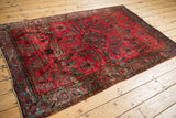 High-angle view of an antique Mohajeran Sarouk showing the lustrous wool and abrashed raspberry field.