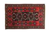 Antique Northwest Persian rug with navy blue stepped medallions on a red field and geometric gul borders.