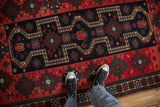 Close-up perspective showing the even pile and geometric stepped medallions of an antique Persian rug.