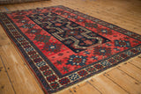 A long perspective showing the antique Persian rug's central column of stepped medallions.