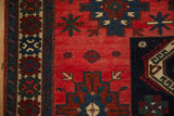 Even wear across the knot heads of a geometric Northwest Persian rug in red and navy blue.