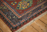 Antique Caucasian Soumac corner showing colorful geometric borders with pawn and wave motifs.
