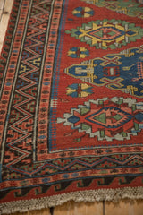 Angled view of an antique Soumac border showing the reciprocal wave and pawn design motifs.