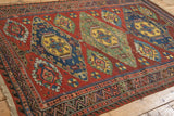 Close-up of the geometric wave and pawn motifs on an antique Caucasian Soumac flatweave rug.