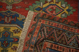 Corner of an antique Caucasian Soumac rug turned over, revealing the intricate reverse weave and side finish.