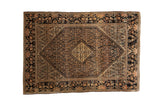 Antique Farahan Sarouk rug with a diamond medallion over a navy Herati field and wide floral borders.