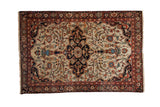Finely woven antique Farahan Sarouk rug with a scalloped navy medallion over a densely patterned ivory field.