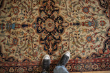 Finely woven wool pile of an antique Farahan Sarouk, detailing its dark medallion and floral field.