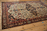 Antique Farahan Sarouk rug from a perspective angle, displaying its intricate floral field and medallion.