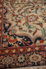 Unique dragon-style spandrel and floral border on a finely woven antique Farahan Sarouk rug.