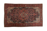 Antique Persian Farahan Sarouk rug with a scalloped navy medallion, dense tree of life motifs, and a red floral border.