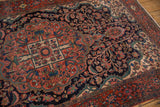 Angled perspective on the dense, sprawling tree of life ornamentation of a Farahan Sarouk.