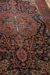 Angled view highlighting the low pile and sprawling floral motifs of an antique Persian rug.