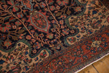 Antique Farahan Sarouk corner showing dense floral ornamentation and its intricate madder red border.