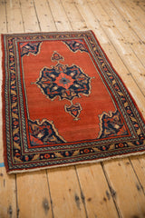Vintage Persian Bijar rug viewed from a side angle, showcasing its traditional design and rich colors.