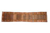 Vintage Kurdish runner, floral trellis design with heavy abrashes. Madder red, charcoal, green gold, 2'10