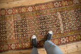 Vintage Kurdish runner's allover floral pattern with heavy abrash, madder red, blush, and green-gold tones.