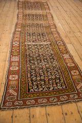 Vintage Kurdish runner border with madder root red, green-gold, and stylized floral motifs.