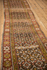 Vintage Kurdish runner with repeating trellis leaf and blossom pattern in charcoal, red, gold.