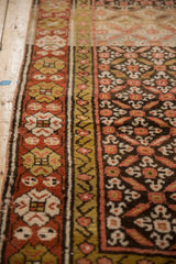 Vintage Kurdish runner detail: madder red border, green gold, blush floral trellis field.