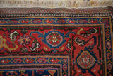 Corner detail of an antique Kurdish rug showing the turtle motif border and woven kilim end.